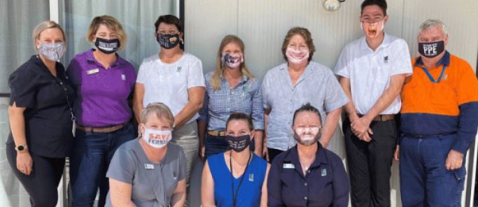 Team of workers in silly face masks