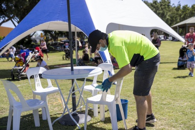 Sanitising chairs at outdoor event